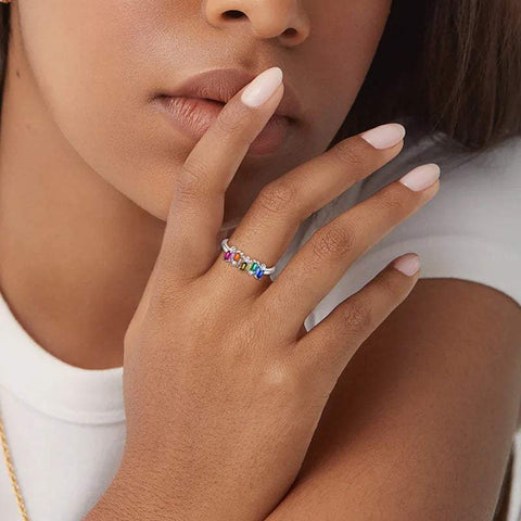 Sterling silver ring with rainbow baguette gemstones in hand
