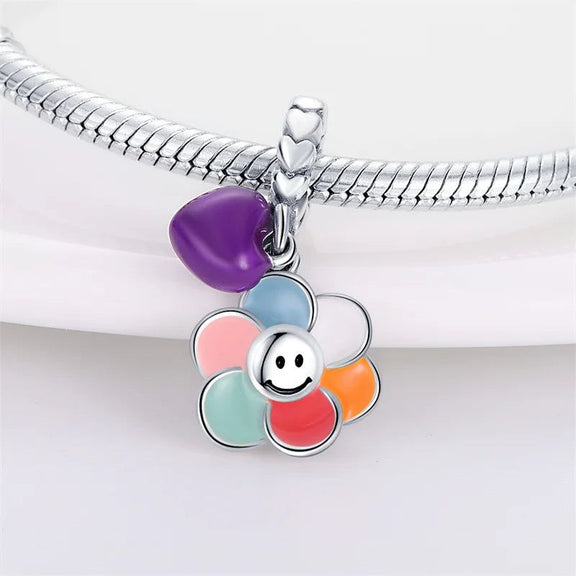 Sterling Silver Smiling Flower and Heart Charm for Pandora Bracelets - Sterling silver charm with a smiling flower and purple heart, fits Pandora bracelets.