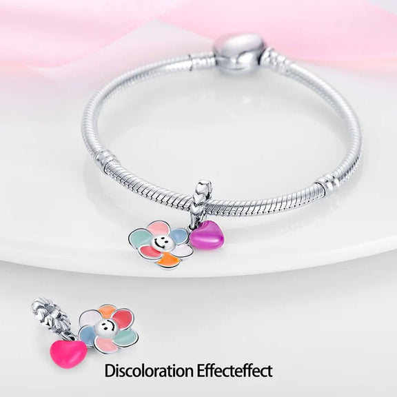 Sterling Silver Smiling Flower and Heart Charm for Pandora Bracelets - Sterling silver bracelet charm featuring a colorful flower with a smile and a purple heart.