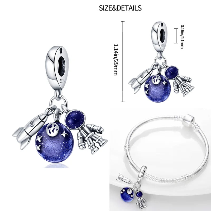 Sterling silver space adventure charm featuring a rocket, astronaut, and moon with blue enamel, fits Pandora bracelets.