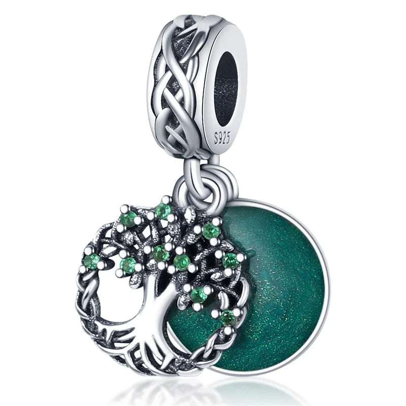 Elegant charm featuband a tree of life and green disc, crafted in sterling silver with green stones.