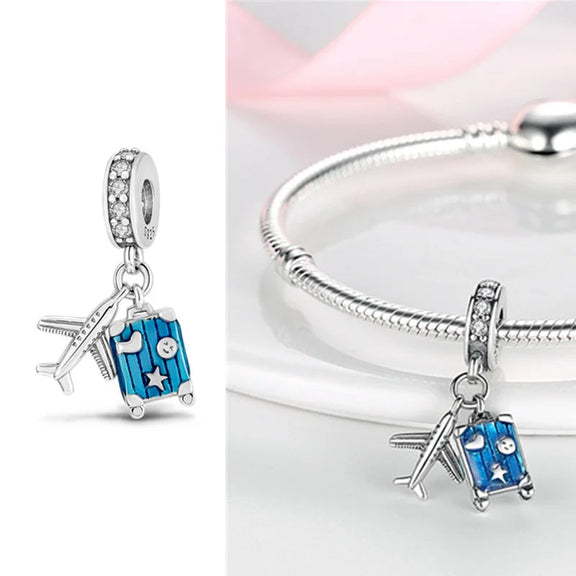 Travel Themed Charm with Blue Suitcase and Airplane in Sterling Silver - Sterling silver travel-themed charm with blue suitcase and airplane, adorned with zircon stones and enamel accents.