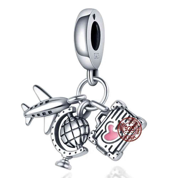 Wanderlust Travel Charm with Airplane, Globe, and Suitcase - Sterling silver travel charm with airplane, globe, and suitcase with pink heart accent.