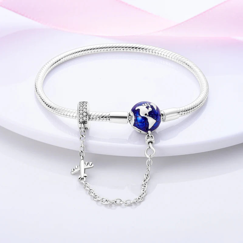 Elegant silver bracelet with a world map charm and airplane detail, great for celebrating your wanderlust.