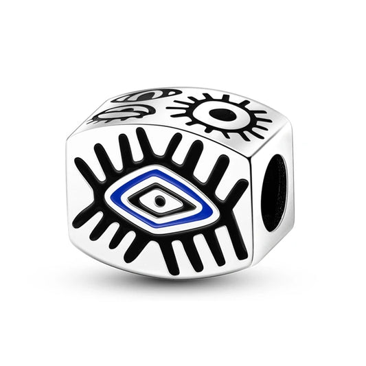 Sterling silver charm with an abstract evil eye design, black and blue enamel accents, perfect for bracelets or necklaces.