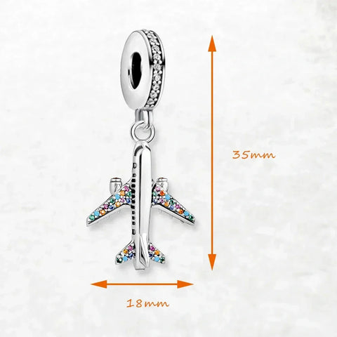 Silver airplane charm with colorful gemstones.
