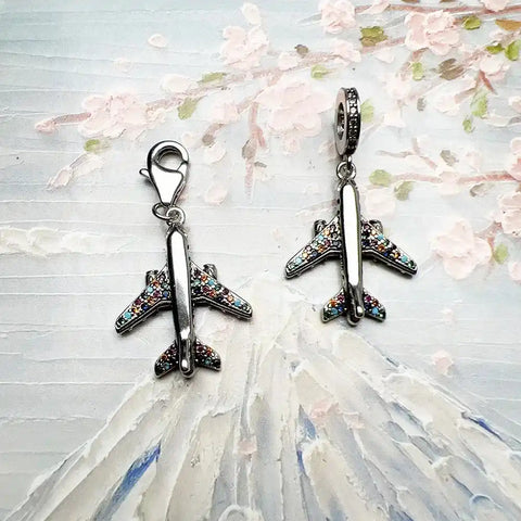 Airplane charm pendants with colorful rhinestones.