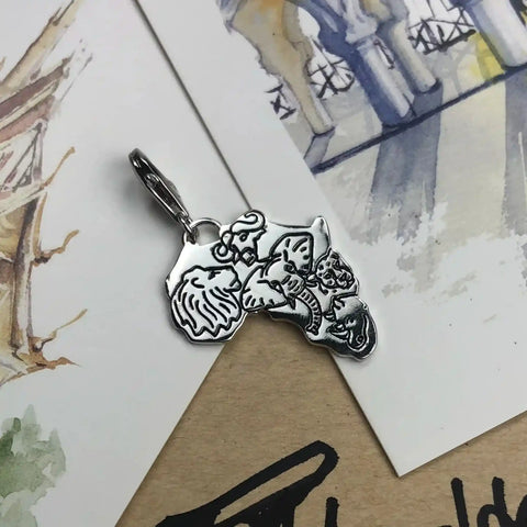 Silver Africa-shaped charm with animal engravings.