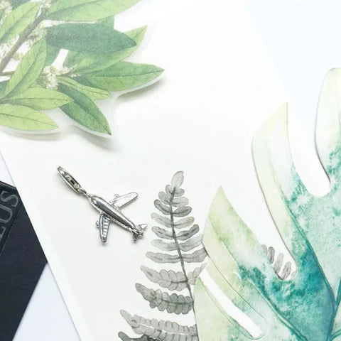 Silver airplane charm.