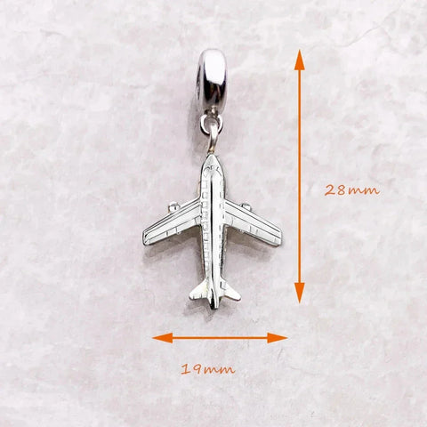 Silver airplane charm.