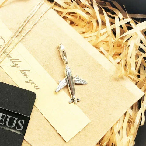 Silver airplane charm.