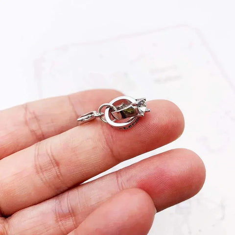 Silver charm with a gemstone.