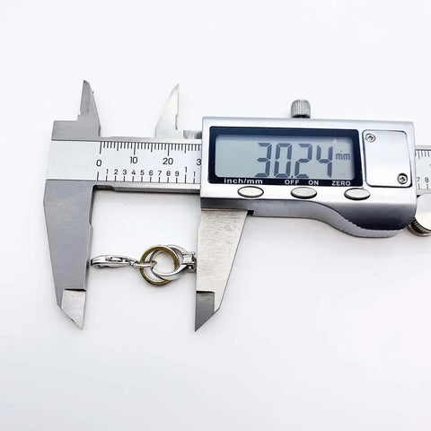 Digital caliper measuring a metal clasp.