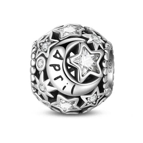 Silver charm with stars and moon.