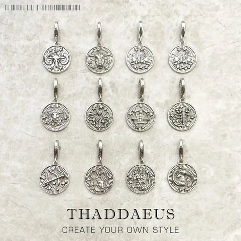 Silver zodiac sign pendant earrings.