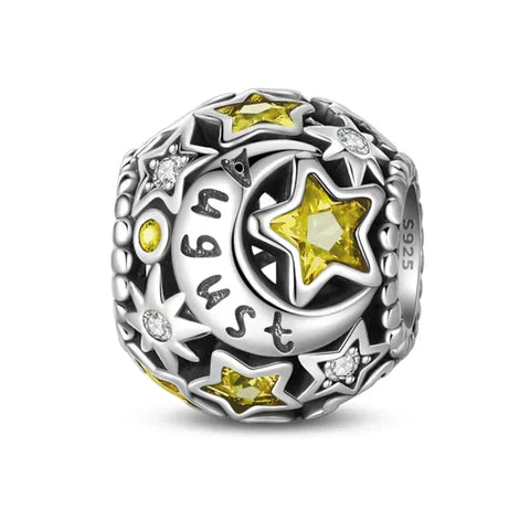 Silver charm with yellow stars and moon.