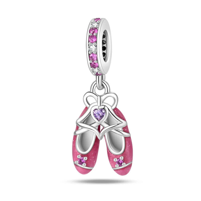 A sterling silver charm featuring ballet shoes with pink enamel and zirconia stones, perfect for dancers and ballet lovers.