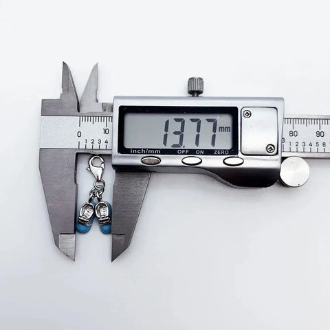 Digital caliper measuring a shoe charm.