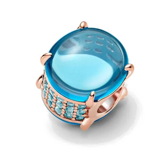 Blue topaz crystal charm with rose gold-plated sterling silver frame for a luxurious and elegant look.
