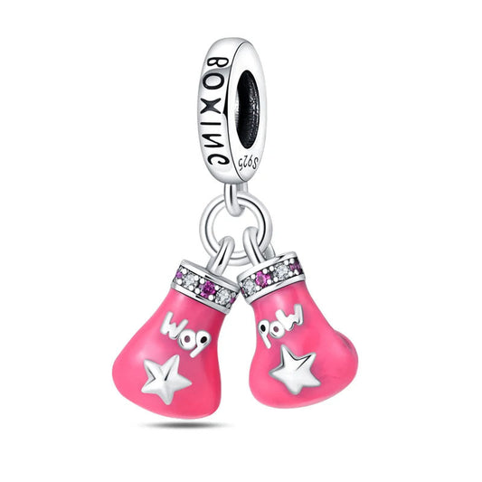 Pink boxing gloves charm with decorative accents.