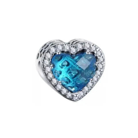 Sterling silver heart-shaped charm with brilliant blue crystal and cubic zirconia accents for a vibrant look.