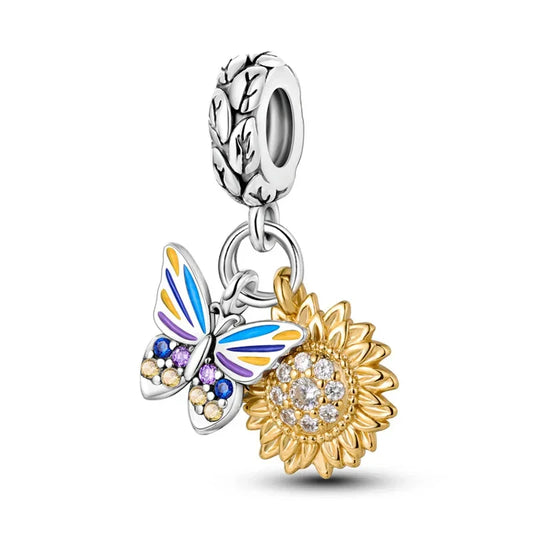 Sterling silver and gold-plated butterfly and sunflower charm with colorful enamel and crystal details.