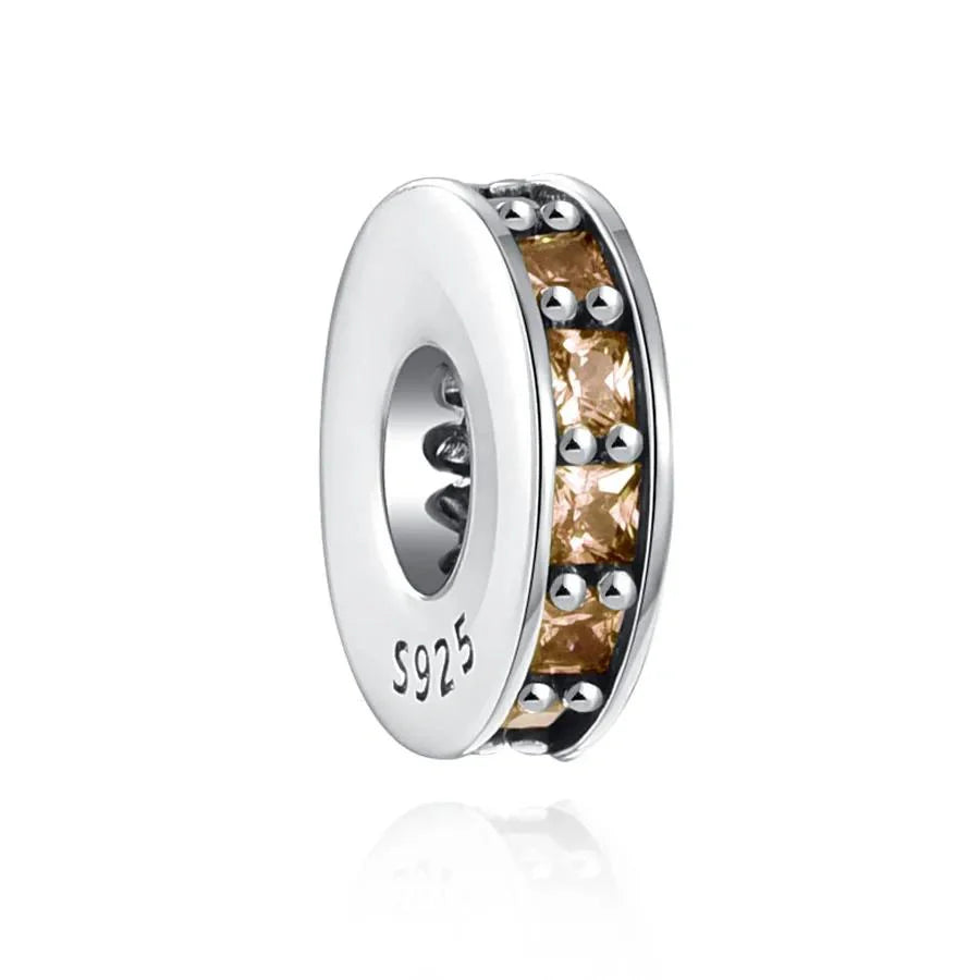 Sterling silver spacer charm with champagne-colored cubic zirconia stones for a subtle and sophisticated look.