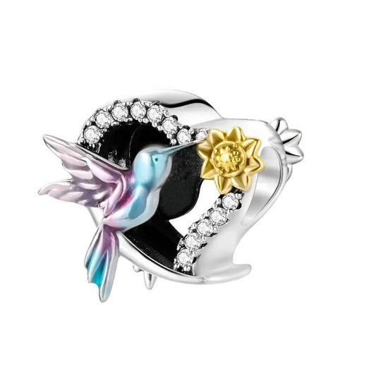 Sterling silver hummingbird charm with enamel and crystal accents.