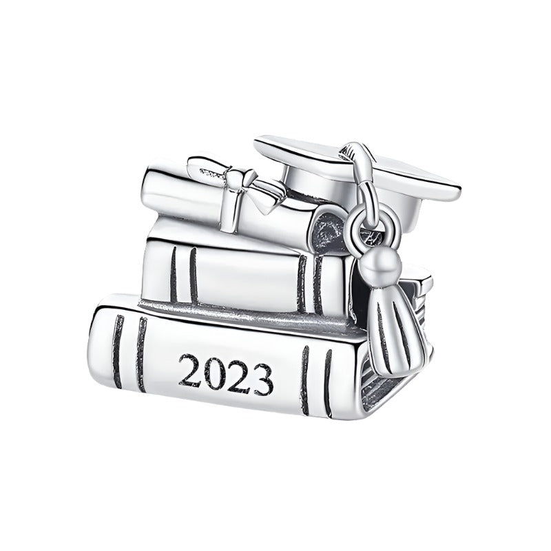 Sterling silver graduation charm with books, diploma, and cap, engraved with 2023.