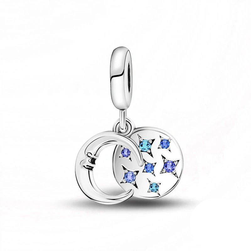 Sterling silver moon and stars dangle charm with blue crystals.