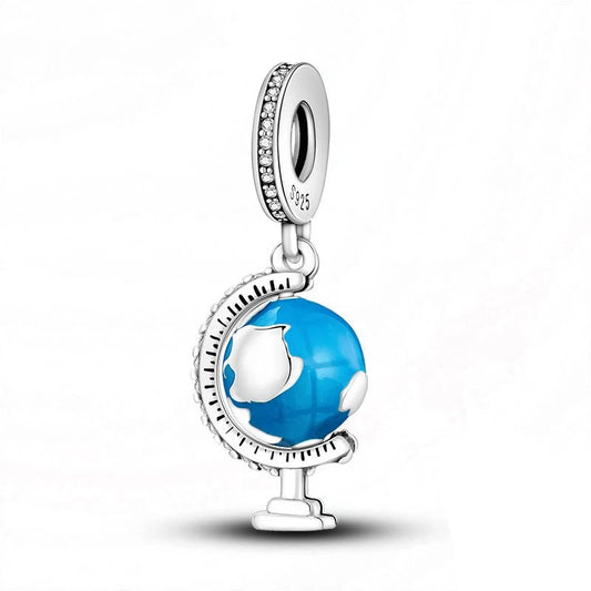 Sterling silver globe dangle charm with blue enamel and cubic zirconia accents.