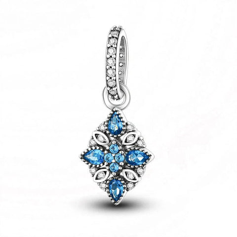 Sterling silver snowflake charm with blue and white crystals.