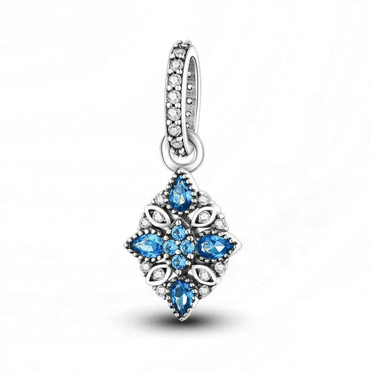 Sterling silver snowflake charm with blue and white crystals.