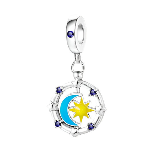 Sterling silver sun and moon charm with enamel and crystals.