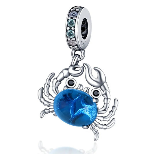 Sterling silver blue crab charm with blue crystal.