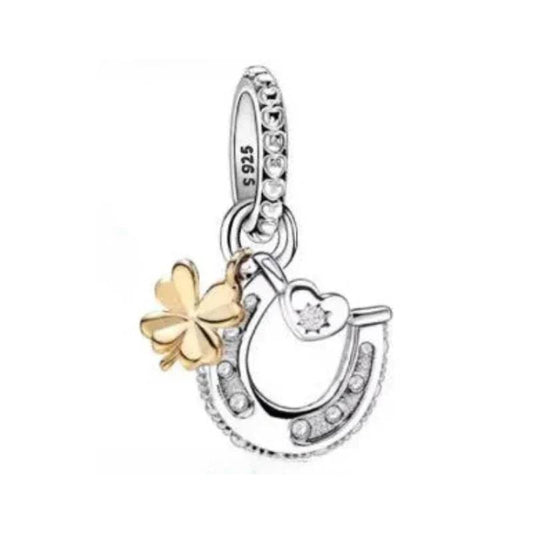 Silver horseshoe charm with gold clover and crystals, adding luck to Pandora bracelet charms.