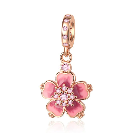 Rose gold flower charm with colorful enamel accents.