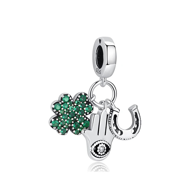 Sterling silver charm featuband a green clover, protective hand, and horseshoe with cubic zirconia.