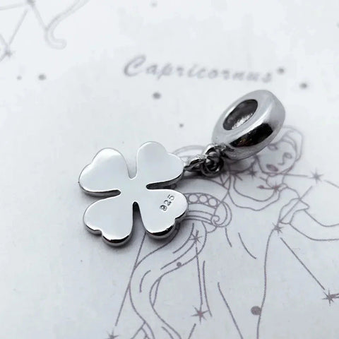 Silver four-leaf clover charm.