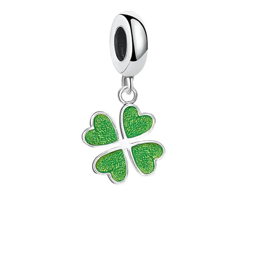 Silver charm with green four-leaf clover.