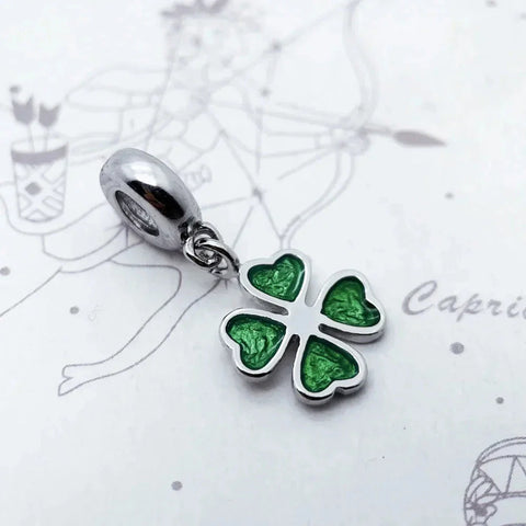 Silver and green clover charm.