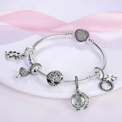 Sterling silver bracelet with a heart charm encrusted with shimmeband stones.