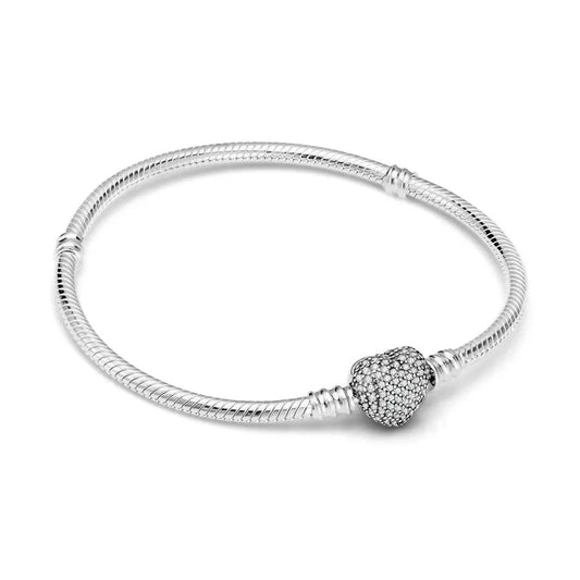 Sterling silver bracelet with a heart charm encrusted with shimmeband stones.