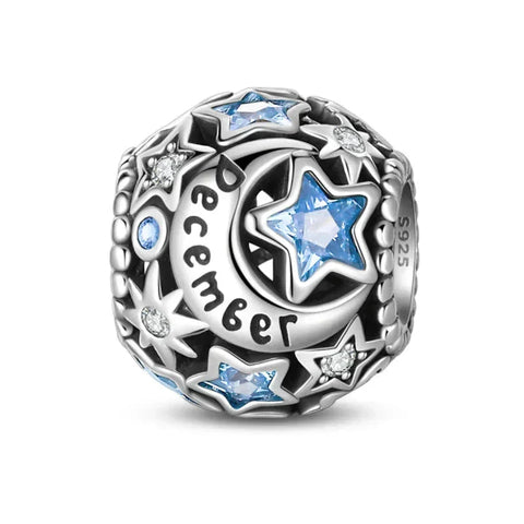 Silver charm with blue stars and 'December' inscription.