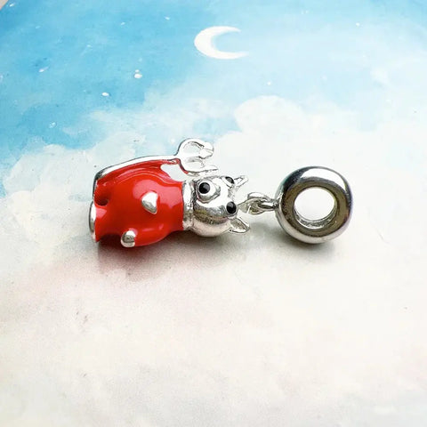 Red and silver cow charm.