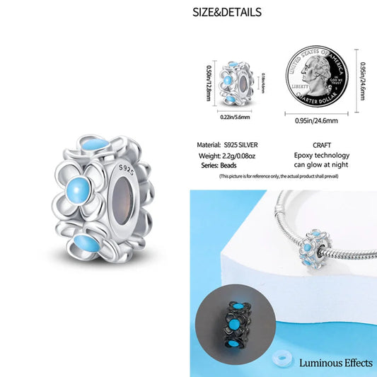 Sterling silver charm featuband delicate flowers with luminous blue epoxy accents that glow in the.