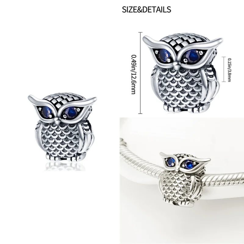 Sterling silver owl charm with sparkling sapphire blue eyes for Pandora bracelets.