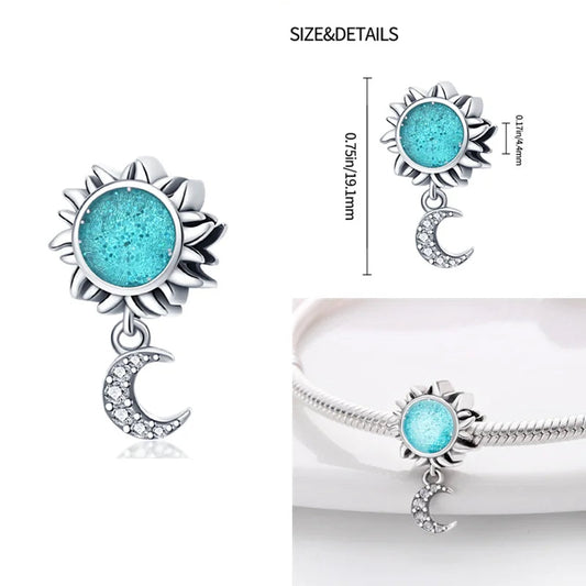 Sterling silver sunflower charm with blue enamel center and a dangling moon, fits Pandora bracelets.