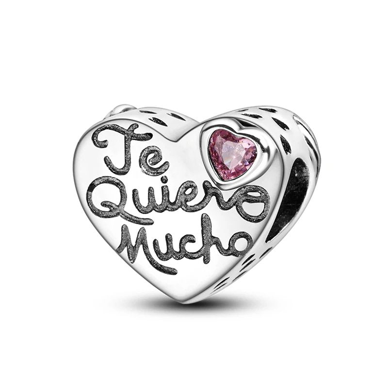 Sterling silver "Te Quiero Mucho" heart charm with pink gem.