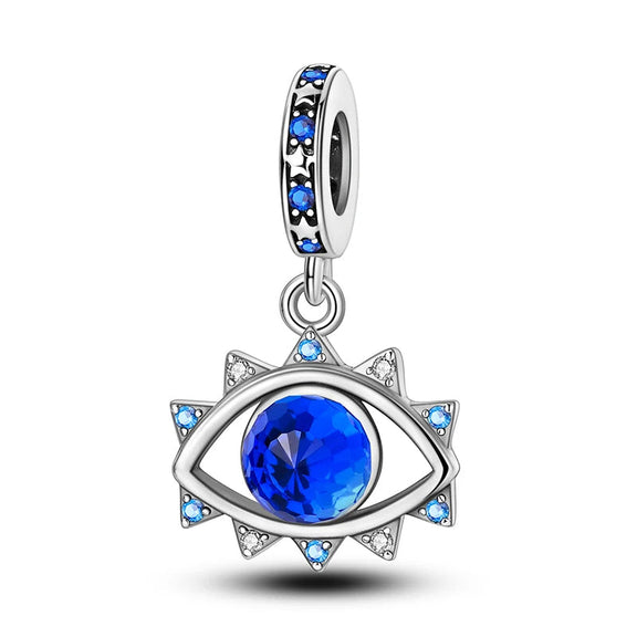 Protective Eye Sterling Silver Charm with Blue Gemstones - Sterling silver protective eye charm with a central blue gemstone and smaller blue and clear stones.